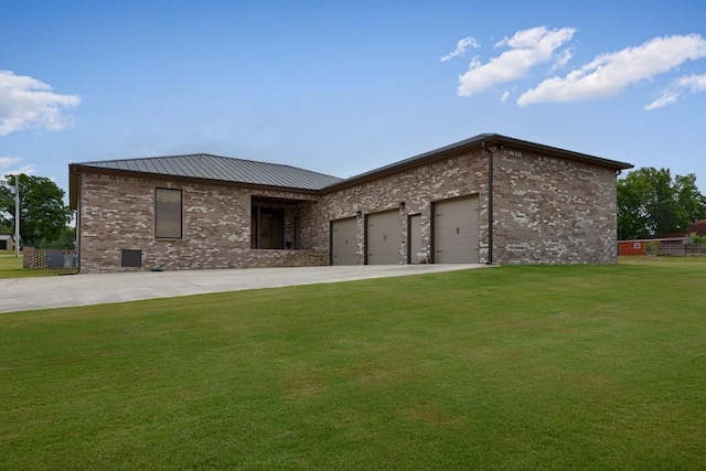 18543 Tillman Mill Rd, Athens, AL 35614 - back of property featuring an attached garage, a yard, brick siding, and concrete driveway