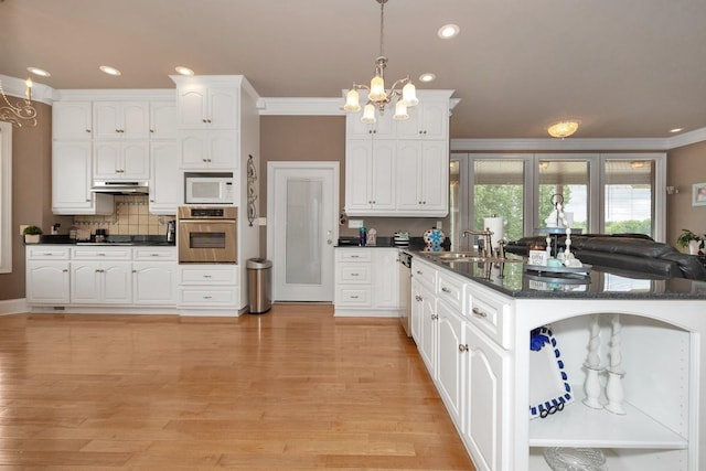 18707 Tillman Mill Rd, Athens, AL 35614 - kitchen featuring appliances with stainless steel finishes, a peninsula, under cabinet range hood, white cabinetry, and a sink