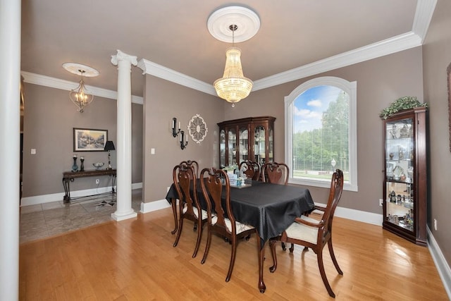 18707 Tillman Mill Rd, Athens, AL 35614 - dining area featuring a chandelier, ornamental molding, light wood-style flooring, and ornate columns