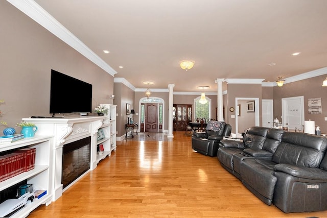 18707 Tillman Mill Rd, Athens, AL 35614 - living area with a glass covered fireplace, crown molding, light wood-type flooring, ornate columns, and recessed lighting