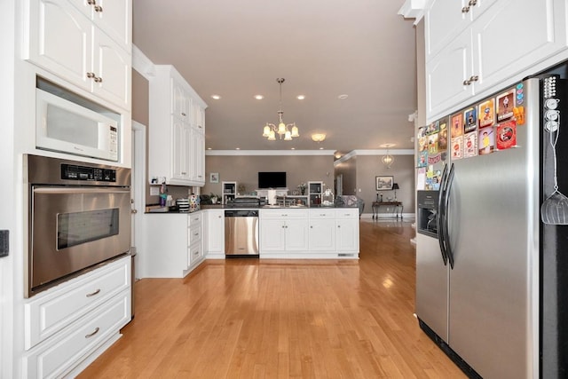 18707 Tillman Mill Rd, Athens, AL 35614 - kitchen with white cabinets, dark countertops, appliances with stainless steel finishes, a peninsula, and a chandelier