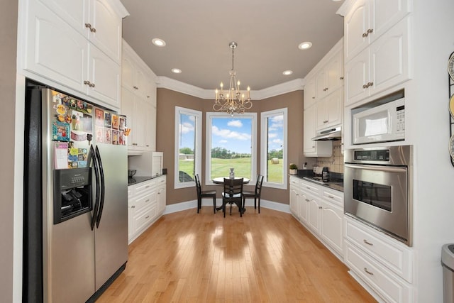 18707 Tillman Mill Rd, Athens, AL 35614 - kitchen featuring stainless steel appliances, dark countertops, white cabinetry, and under cabinet range hood