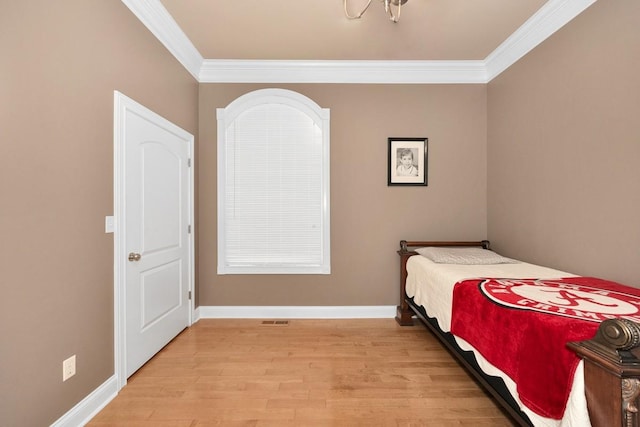 18707 Tillman Mill Rd, Athens, AL 35614 - bedroom featuring light wood-style floors, ornamental molding, and baseboards