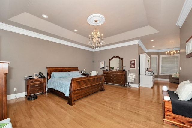 18707 Tillman Mill Rd, Athens, AL 35614 - bedroom featuring light wood-style floors, a tray ceiling, and an inviting chandelier