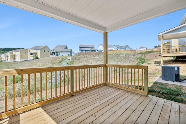 deck with a residential view and central AC unit