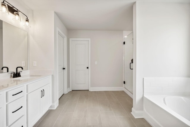 full bathroom with a stall shower, baseboards, tile patterned floors, vanity, and a bath