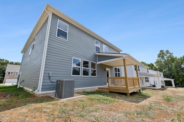 rear view of house featuring a deck and cooling unit