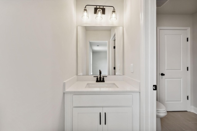 bathroom with toilet and vanity