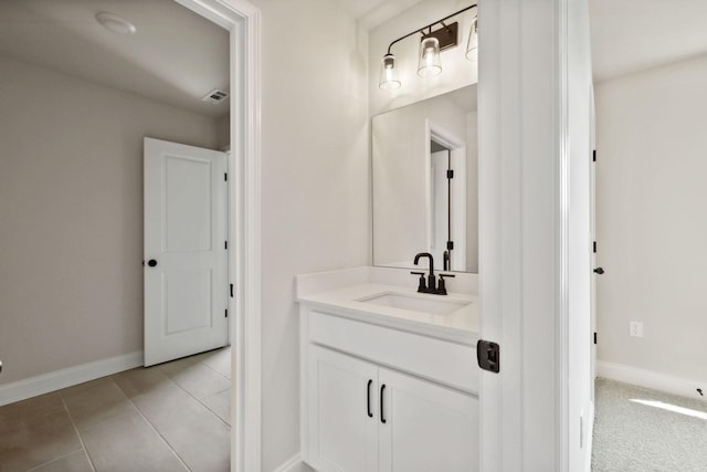 bathroom featuring tile patterned floors, vanity, visible vents, and baseboards