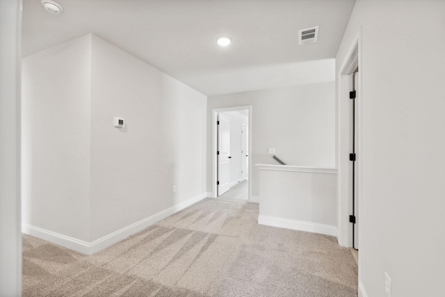 corridor featuring carpet, visible vents, and baseboards