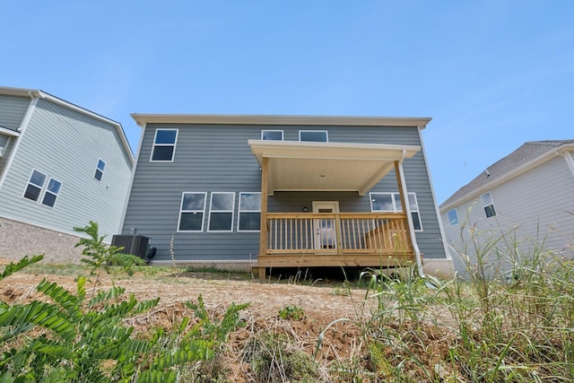 rear view of house featuring a wooden deck and central air condition unit