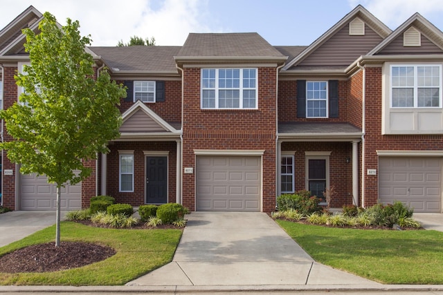 view of property featuring concrete driveway, brick siding, and an attached garage