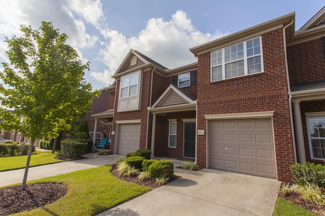 multi unit property featuring an attached garage, concrete driveway, and brick siding