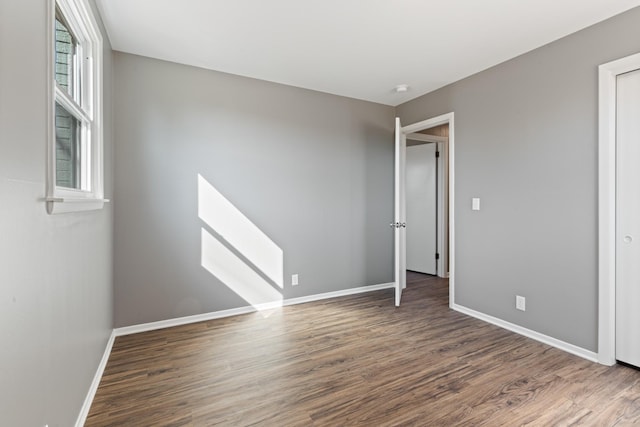 unfurnished bedroom featuring baseboards and wood finished floors