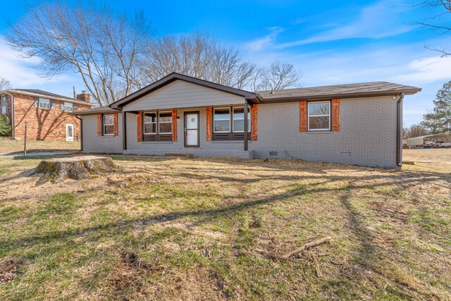 view of front of property featuring a front yard, crawl space, and brick siding