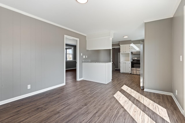 unfurnished living room featuring ornamental molding, dark wood finished floors, and baseboards