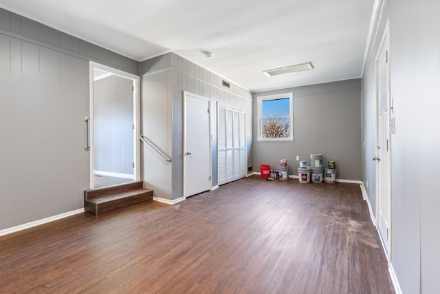 interior space featuring wood finished floors, visible vents, and baseboards