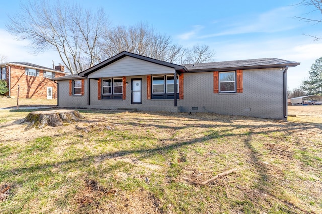 view of front facade featuring a front yard, crawl space, and brick siding