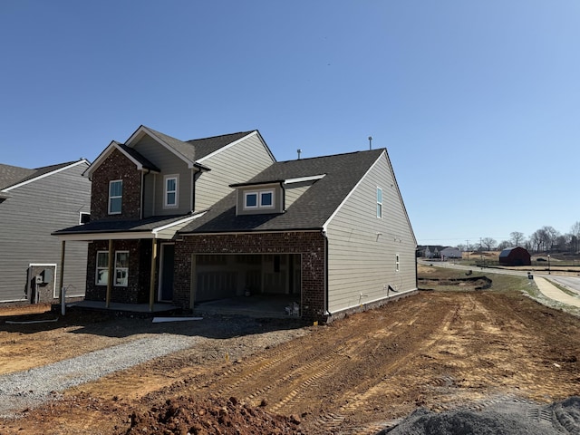 view of front of property with brick siding, driveway, and an attached garage