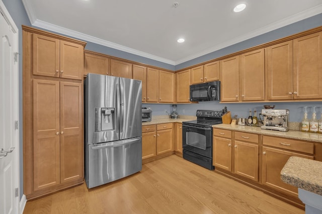 kitchen featuring light stone counters, recessed lighting, light wood-style floors, ornamental molding, and black appliances