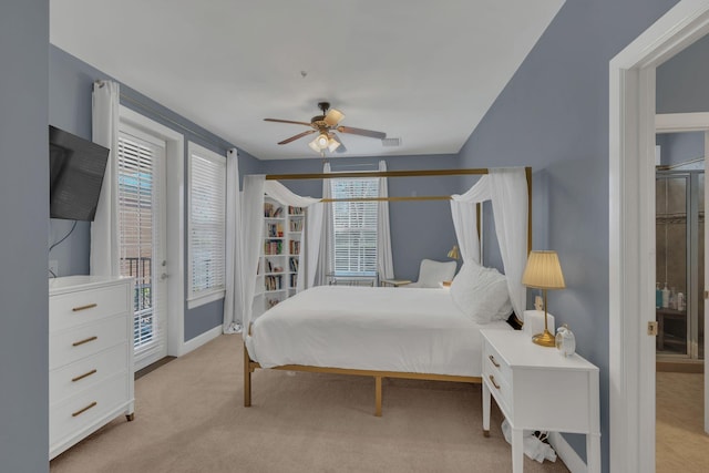 bedroom with access to exterior, light colored carpet, visible vents, ceiling fan, and baseboards