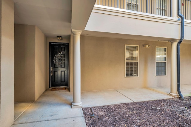 property entrance featuring a patio and stucco siding