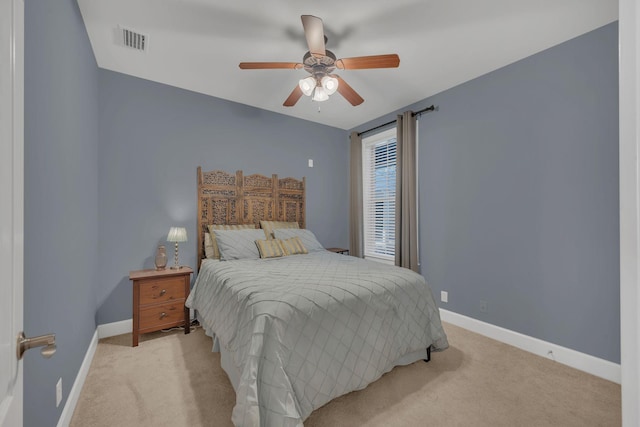 bedroom featuring baseboards, visible vents, and light colored carpet