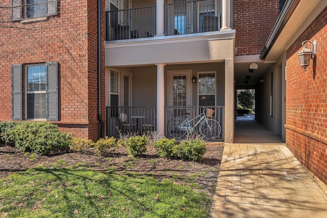 doorway to property with brick siding