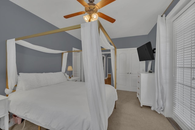 bedroom with lofted ceiling, carpet, and a ceiling fan