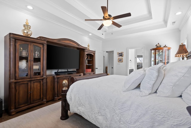 bedroom with recessed lighting, a ceiling fan, visible vents, ornamental molding, and a tray ceiling