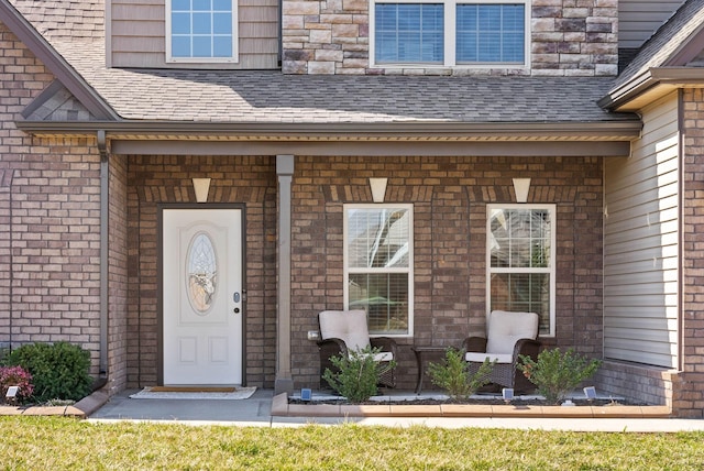 property entrance featuring a shingled roof and a porch