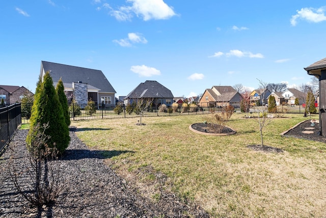 view of yard featuring a residential view and fence