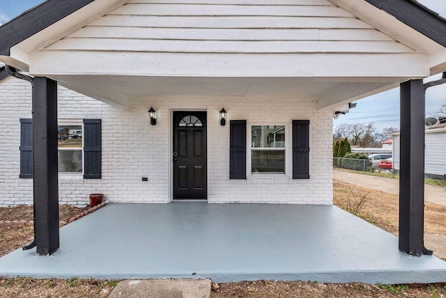 entrance to property featuring brick siding