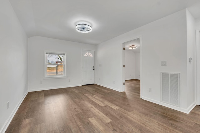 entryway featuring visible vents, baseboards, and wood finished floors