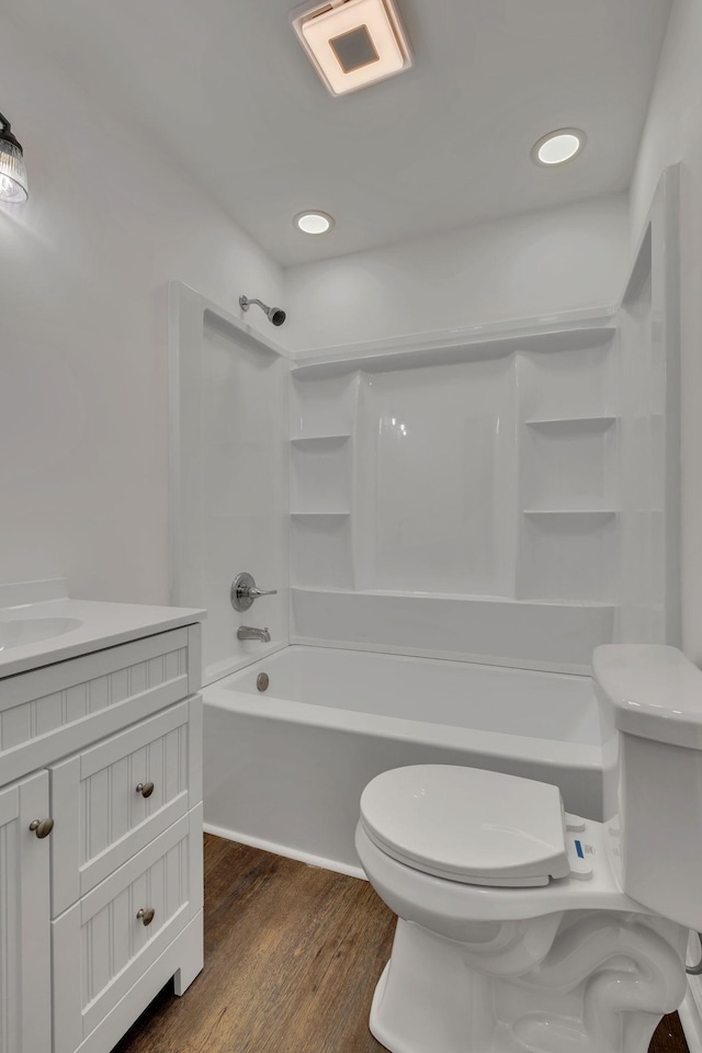 bathroom featuring bathtub / shower combination, visible vents, toilet, vanity, and wood finished floors