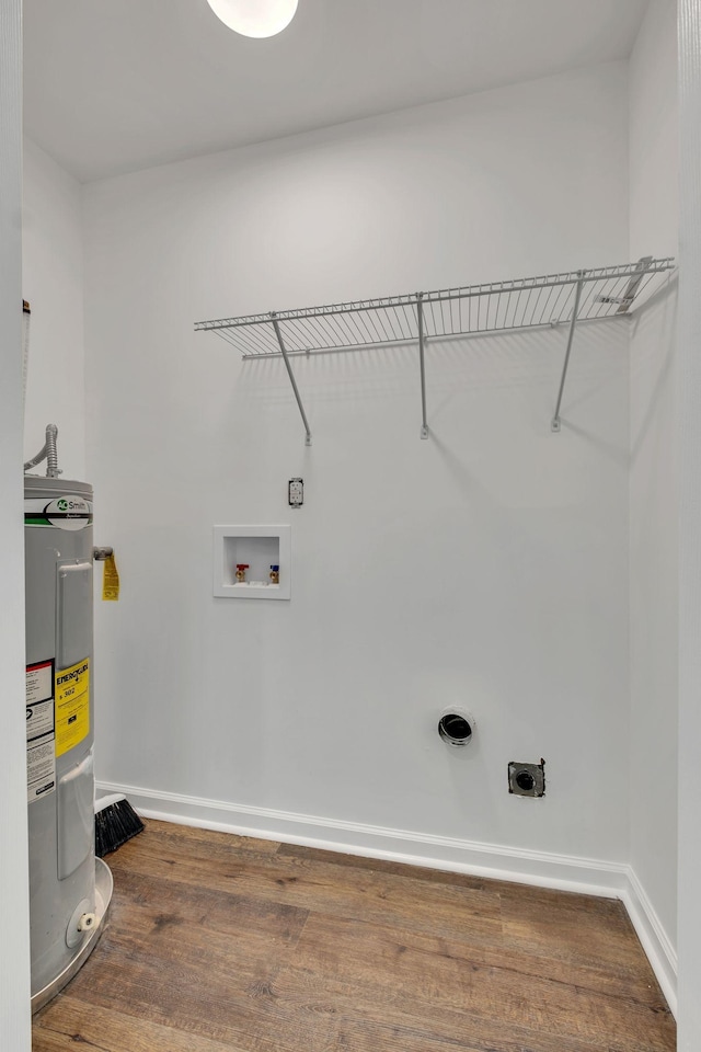 laundry area featuring dark wood finished floors, hookup for a washing machine, water heater, hookup for an electric dryer, and laundry area