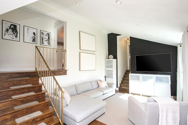 living area with lofted ceiling, recessed lighting, and stairs