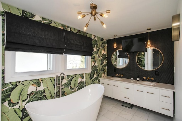 bathroom featuring double vanity, a sink, and wallpapered walls