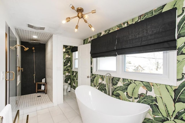 bathroom featuring a freestanding tub, toilet, visible vents, a shower stall, and wallpapered walls