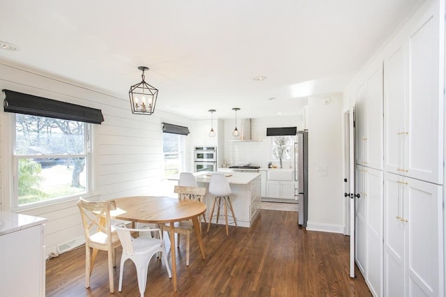 dining space with dark wood-type flooring