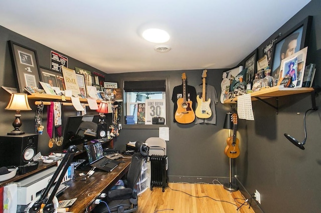 home office featuring baseboards, visible vents, and wood finished floors