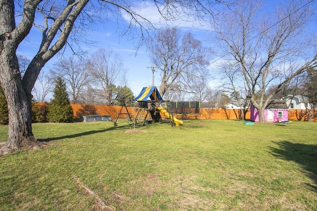 view of yard featuring a playground, an outdoor structure, a fenced backyard, and a storage shed