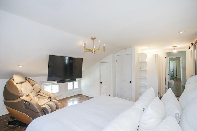 bedroom featuring a notable chandelier, baseboards, and wood finished floors