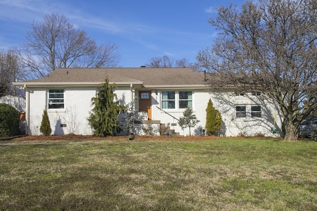 ranch-style house featuring crawl space, a shingled roof, a front lawn, and brick siding