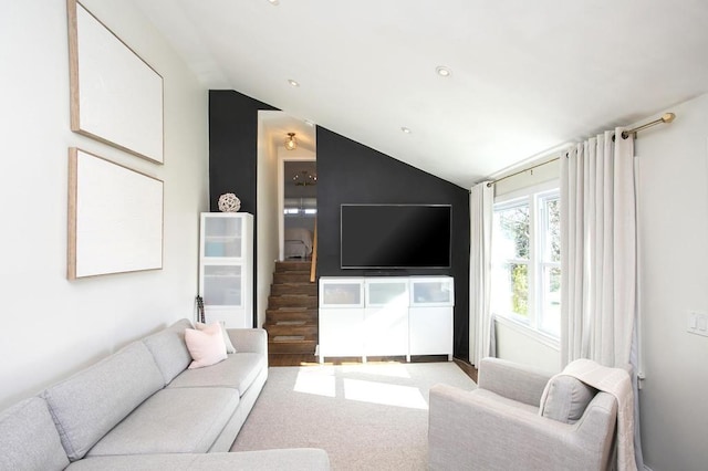 living area with lofted ceiling and carpet