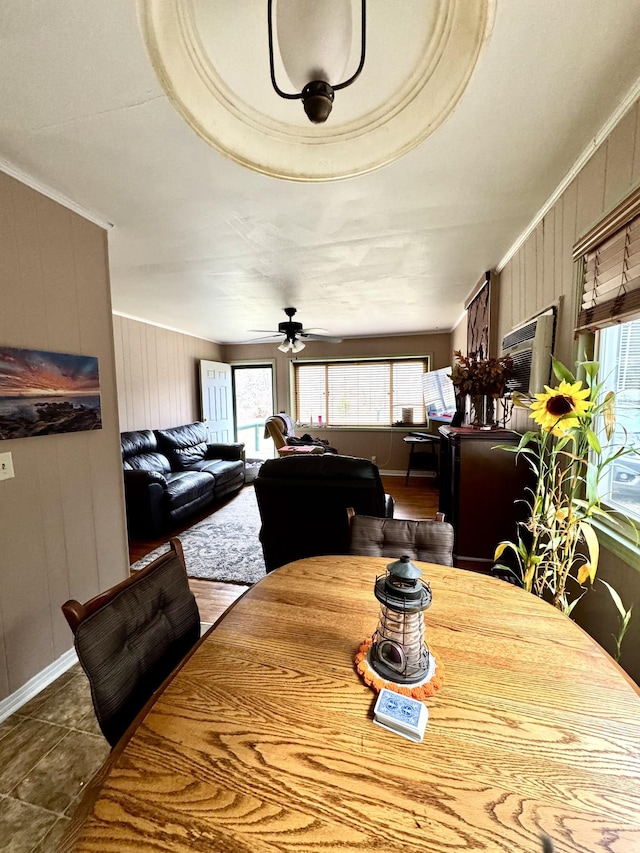 dining space with ornamental molding, ceiling fan, and dark tile patterned floors