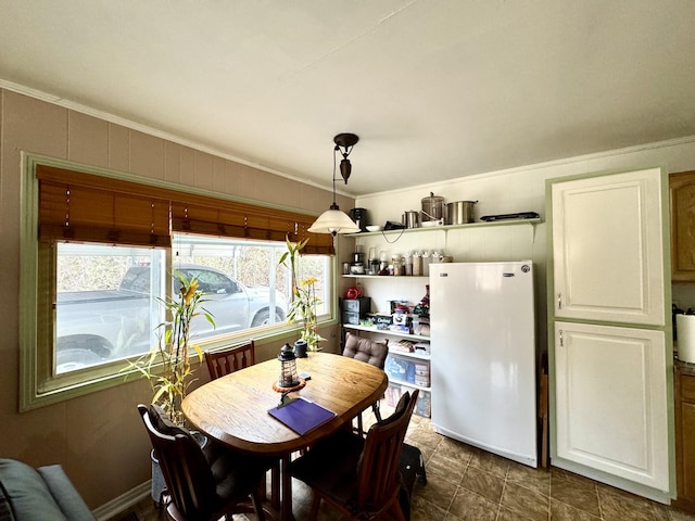 dining space featuring ornamental molding and washer / clothes dryer