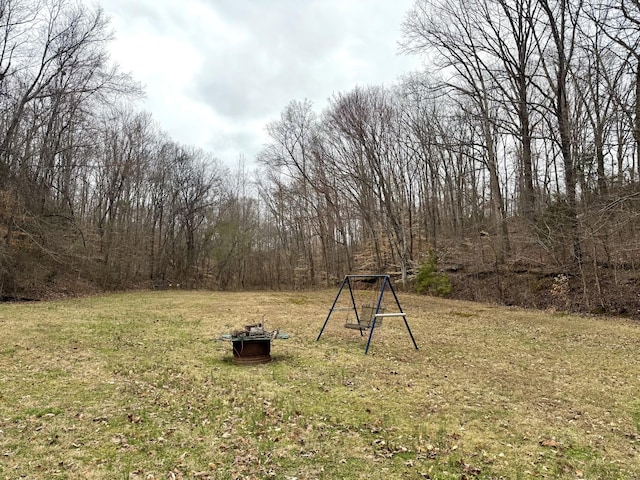 view of yard with a fire pit