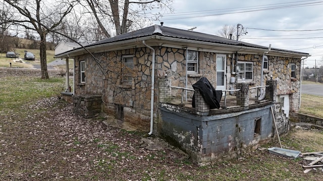 view of side of home featuring stone siding