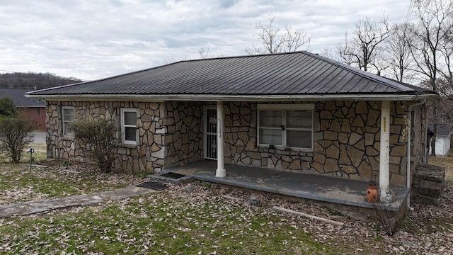 bungalow with stone siding and metal roof